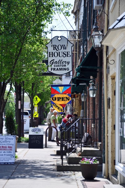 "Street scene of an old Main street lined with shops and signs"